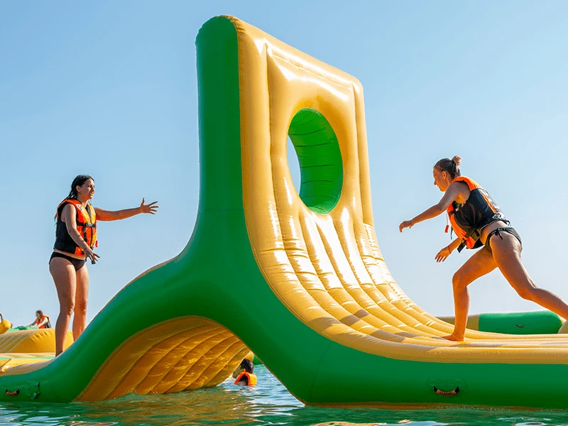 adults playing on inflatables
